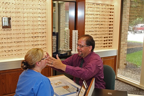 Vince Valentino fitting a woman with Eyeglasses