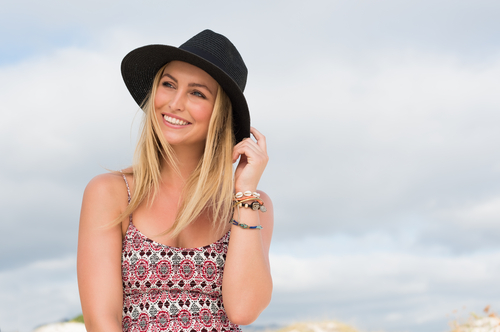 Happy Young Woman Smiling at the Beach after LASIK Surgery