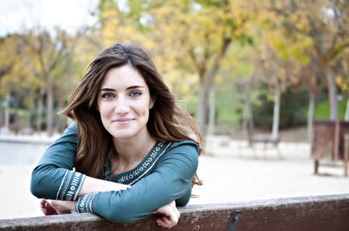 Smiling Young Woman on Park Bench