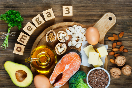 An array of food with wooden blocks spelling out OMEGA 3