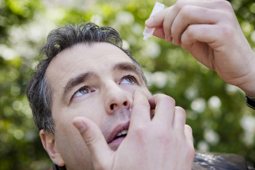 Man inserting eye drops to relieve dry eye