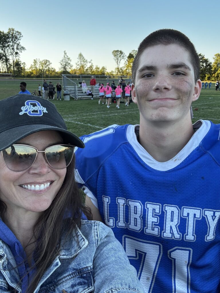 Dr. San Filippo with her son at a Liberty football game